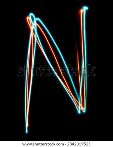 Letter N of the alphabet made from neon sign. The blue red light image, long exposure with colored fairy lights, against a black background. Concept of design Royalty-Free Stock Photo #2342319525