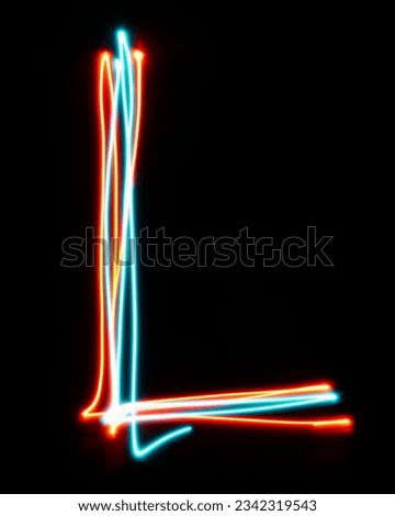 Letter L of the alphabet made from neon sign. The blue red light image, long exposure with colored fairy lights, against a black background. Concept of design