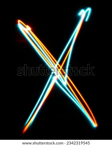 Letter X of the alphabet made from neon sign. The blue red light image, long exposure with colored fairy lights, against a black background. Concept of design