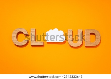 The word "Cloud" in wooden letters on a yellow background