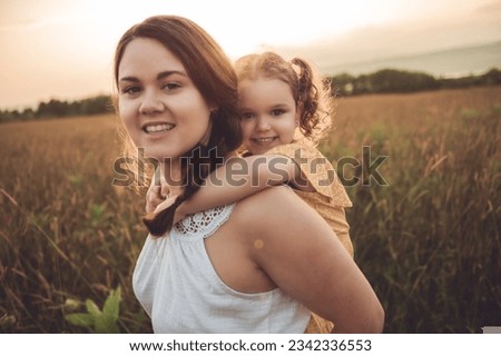 A Happy family mother with children daughter on nature sunset