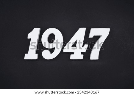 Black for the background. The number 1947 is made of white painted wood.