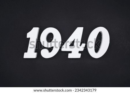 Black for the background. The number 1940 is made of white painted wood. Royalty-Free Stock Photo #2342343179