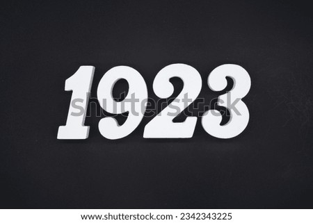Black for the background. The number 1923 is made of white painted wood.
