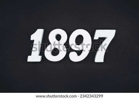 Black for the background. The number 1897 is made of white painted wood.