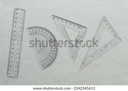 classic geometry instruments (from left to right) ruler, protractor, set square 90 degree and 45 degrees angles and 30, 60, and 90 degrees angles