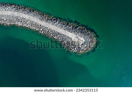zenithal aerial view of a breakwater in turquoise waters Royalty-Free Stock Photo #2342353115