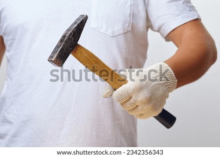 man with hammer in gloves Royalty-Free Stock Photo #2342356343