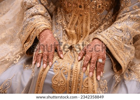 mehendi on the hands of girls,Woman Hands with black mehndi tattoo. Hands of moroccan bride girl with black henna tattoos