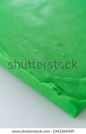 Scoring green fudge into perfect squares for cutting.
