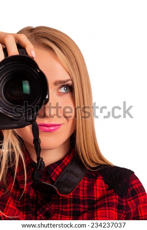 Half of a face of female photographer holding a professional camera - isolated over white