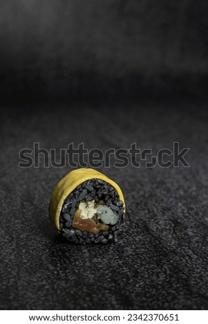 sushi with black rice and cheese on top
