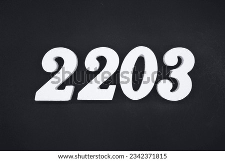Black for the background. The number 2203 is made of white painted wood.