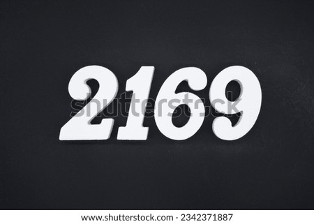 Black for the background. The number 2169 is made of white painted wood.