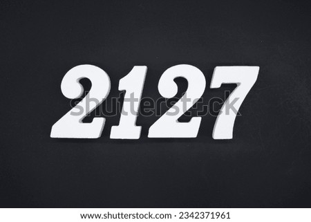 Black for the background. The number 2127 is made of white painted wood.