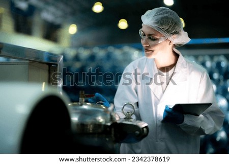 scientist worker checking the quality of Reverse osmosis machine system at the industrial factory. Female worker recording data at the control panel with measure pressure for recycle portable plant. Royalty-Free Stock Photo #2342378619
