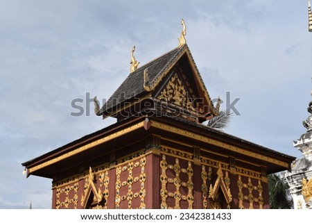 Ho Trai is a place where manuscripts are kept. It is a tall square building under a solid basement. The roof is a gable shape with Cho Fah Bai Raka. It is a combination of Lanna art and Burmese art. Royalty-Free Stock Photo #2342381433