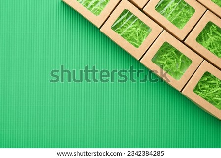 Green Friday backgrounds mock up. Sale Tag on green background. Paper shopping boxes and green tag. Environmentally friendly shopping idea, useful things on sale. Reducing excessive consumption.
