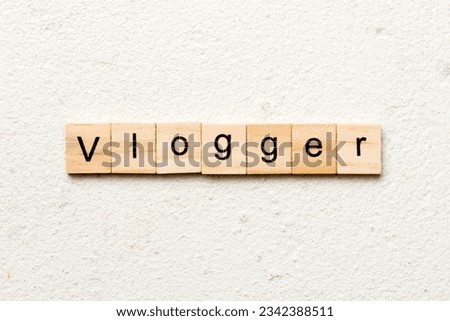vlogger word written on wood block. vlogger text on table, concept. Royalty-Free Stock Photo #2342388511