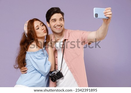 Two traveler tourist woman man couple in shirt do selfie shot mobile phone photo social network blow air kiss isolated on purple background Passenger travel abroad weekend getaway Air flight concept