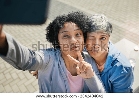 Senior women, selfie and peace, hands and wink in a city for travel, fun and chilling on the weekend outdoor. Face, friends and old ladies pose for profile picture, photo or traveling memory in town