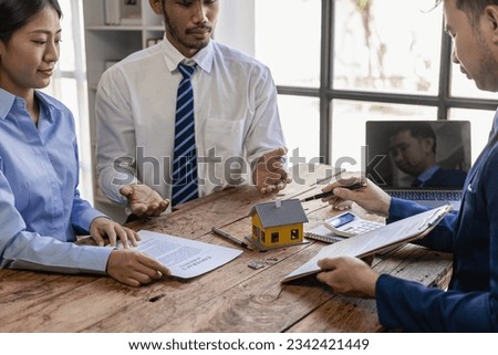 Businessman or real estate agent recommending houses and interest for his client after signing contract in office concept for real estate