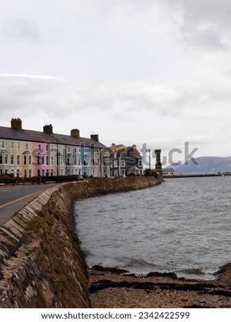 Vertical shot of Caernarvon seafront with row of colourful houses. High quality photo