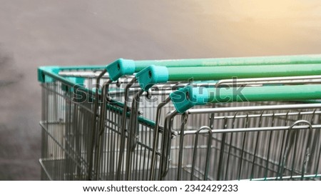 Metal shopping carts on dark background concept of shopping on holiday                               