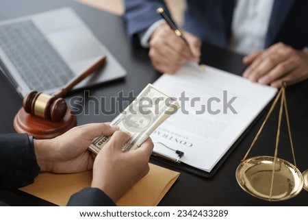Close up view of young lawyer signing the contract after making a deal with his client.