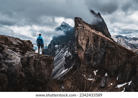 A daring climber conquering the jagged mountainous heights of the Dolomites, part of the Alps in Italy's South Tyrol region Royalty-Free Stock Photo #2342433589