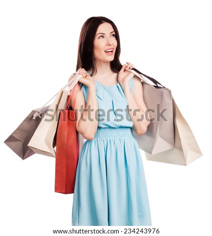 Beautiful young woman carrying shopping bags