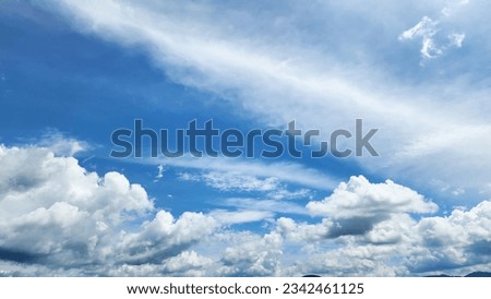 Blue sky and white clouds floated across the sky on a clear day with warm sun combined with a cool breeze blowing on the body, resulting in a wonderful refreshment like heaven