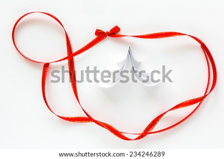 Shiny red and gold border ribbon   on white background with christmas tree paper