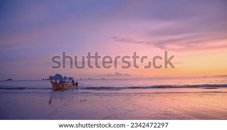 Beautiful amazing sunset over tropical ocean Andaman sea beach with colorful sky and Long tail boats in summer at Ao Nang, Krabi, Thailand, tourism vacation holiday travel trip destination concept Royalty-Free Stock Photo #2342472297