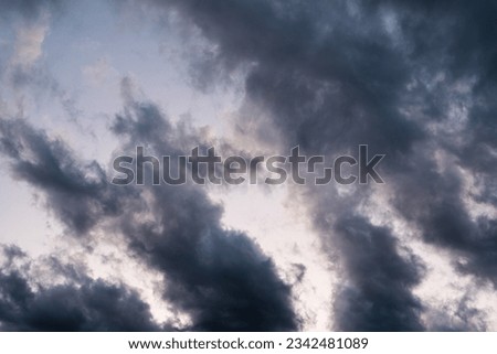 Cloudy sky background, dramatic clouds and blue sky breakthrough. Picture depicts a natural phenomenon with dark, bright and clear areas happened after thunderstorm that can be used as wallpaper.