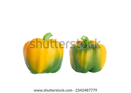 Two yellow peppers on white background.Capsicum annuum on white background.  Royalty-Free Stock Photo #2342487779