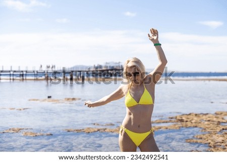 Beautiful happy woman in bikni on tropical beach.