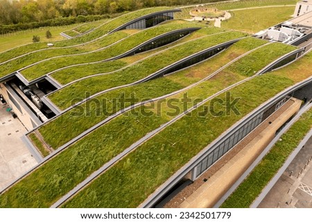 Aerial view of the extensive wildflower green roof or living roof on the net zero rooftop of a green building owned by a responsible business