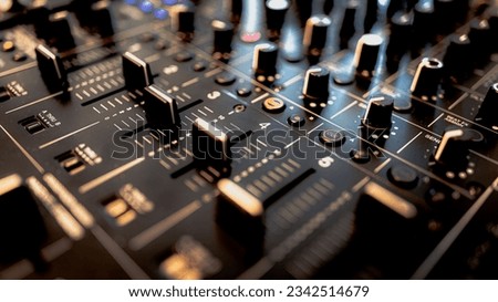 A detailed closeup of the knobs and buttons on a professional audio mixing console