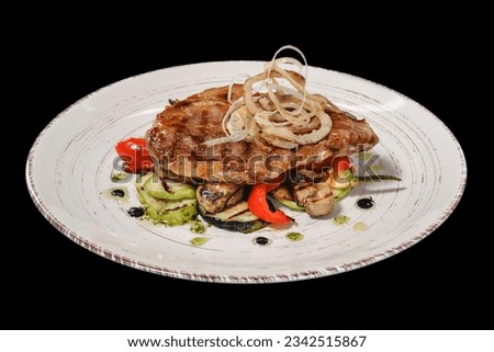 Steak. A piece of steak with grilled vegetables. Isolated on black