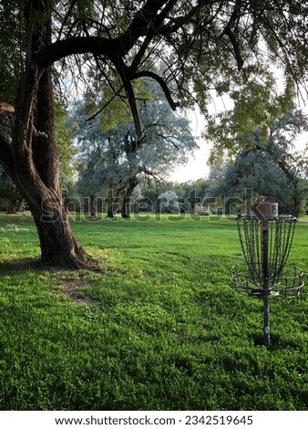 A disc golf basket, also known as a catcher or goal, composed of steel tubes, chains, and bar, on Creekside Disc Golf Park in Salt Lake City, Utah, United States. 