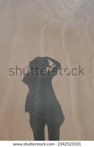 shadow of a photopgrapher at the sand