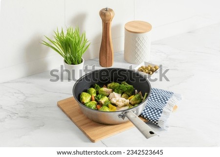 a pan containing an array of colorful healthy vegetables on a modern white marble kitchen countertop, Ready-to-Cook