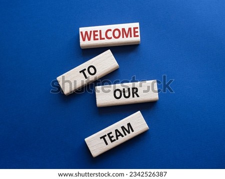 Welcome to our team symbol. Concept words Welcome to our team on wooden blocks. Beautiful deep blue background. Business and Welcome to our team concept. Copy space. Concept word Royalty-Free Stock Photo #2342526387