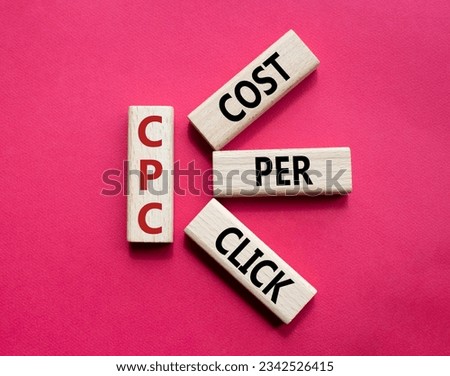 CPC - Cost Per Click symbol. Concept word AGM on wooden cubes. Beautiful red background. Business and AGM concept. Copy space. Concept word