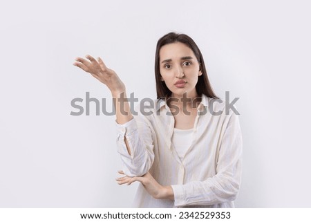 Young beautiful woman with facial expression of surprise standing over white background.