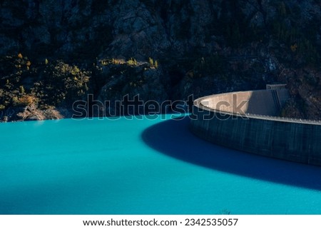 Dam of the Lake Place Moulin, an artificial glacial lake with turquoise water in the italian Alps, on the border with Switzerland Royalty-Free Stock Photo #2342535057