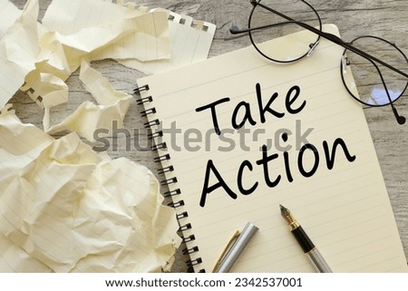 notepad on the desktop. text Take action Royalty-Free Stock Photo #2342537001