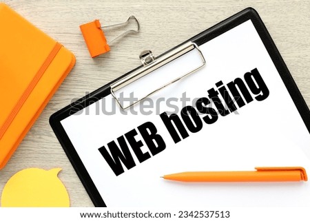 text on white paper on black folder. wooden background. text on paper. web hosting
