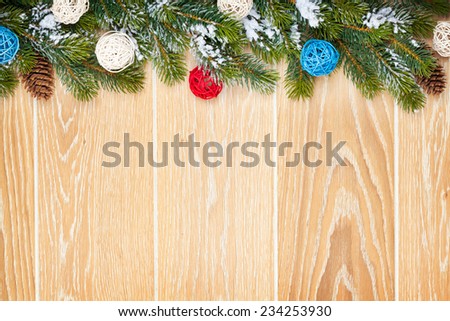 Christmas wooden background with snow fir tree, decor and copy space